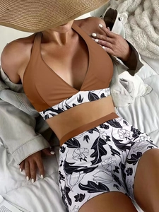 Detailed view of high waist bikini bottoms with black and white floral leaf print
