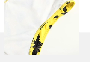 Detailed close-up of white mesh fabric with yellow floral leopard trim and neat stitching