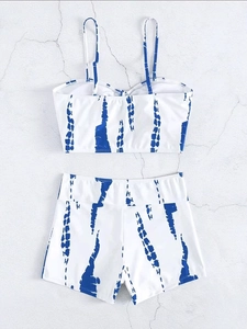 Detailed flat lay of high waisted bikini set with blue tie-dye stripes and drawstring detail
