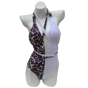 Detail of leopard print swimsuit featuring buckle strap and criss-cross tie design