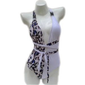 Detail of the leopard print and white patchwork on a one-piece swimsuit with belt