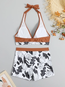 Flat lay of brown and floral high-waisted bikini set with summer beach accessories