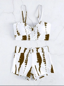 Flat lay of tie-dye high waisted bikini set with adjustable straps and front bow knots