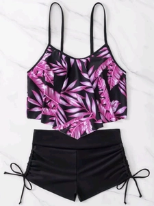 Detail view of high waisted bikini with tropical leaf print and side drawstring shorts