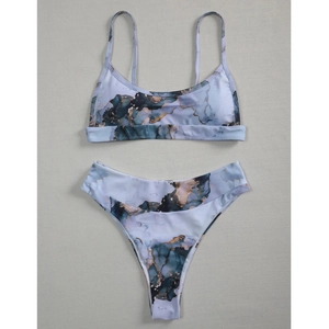 Detailed flat lay of a two-piece tie-dye bikini with blue and gold marble textures