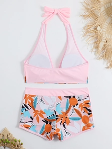 Top bikini rosa con fiocco e slip a vita alta con stampa di foglie tropicali colorate