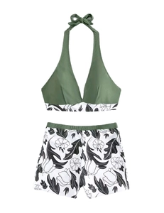 Olive green halter neck bikini top and black and white floral high-waisted swim shorts