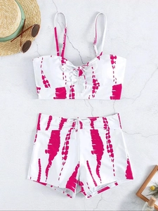 Detailed flat lay of a two-piece tie-dye bikini with high-waisted shorts in white and pink