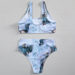 Detailed flat lay of a blue marble print bikini with gold marble textures and high waist