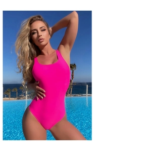 Detail of neon pink one-piece swimsuit with high-cut leg and scoop neck by the pool