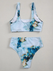 Detailed flat lay of a two-piece high-waisted bikini with blue marble print patterns