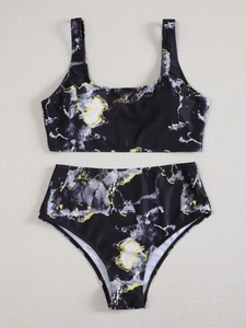 Flat lay of marble print two-piece bikini set with high-waisted bottoms and wide straps