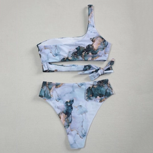 Detail of blue-green marble print bikini with one-shoulder design and high waist bottom