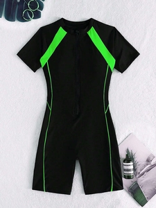 Flat lay of women's short sleeve surfing swimsuit with front zipper and neon green details