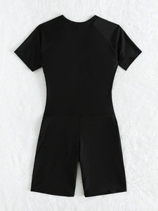 Rear view of black short sleeve one-piece swimsuit with raglan sleeve seams on plush background