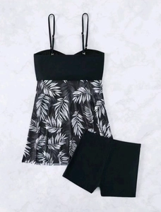 Detail of two-piece tankini set featuring tropical leaf print top and high waist boy shorts