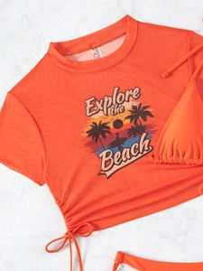 Detail of orange high-waisted bikini with drawstring crop top and tropical sunset graphic