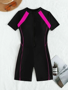 Detailed flat lay of black short sleeve surfing swimsuit with pink stripes and front zipper