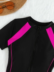 Close-up of sporty one-piece swimsuit with pink contrast panels and front zipper