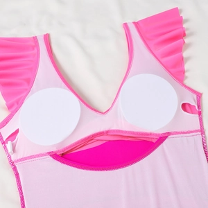 Detail view of pink one-piece swimsuit featuring interior chest pads and ruffle shoulders
