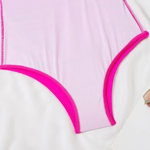 Detail of pink one-piece swimsuit crotch showing soft mesh lining and premium stitching