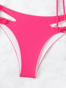 Close-up of bright pink bikini bottom featuring side cut-outs and stylish tie straps