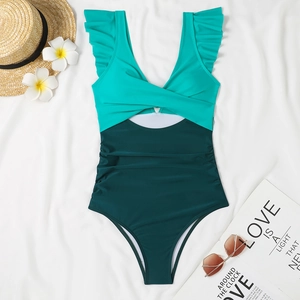 Flat lay of a one-piece swimsuit with ruffle trim, V-neck and color block design