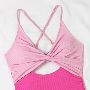 Close-up of pink ribbed swimsuit with front knot detail and adjustable straps