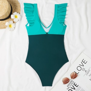 Detailed flat lay of color-block one-piece swimsuit with V-neck and ruffled shoulder straps