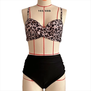 Detail of leopard print bikini top with twist knot and high-waisted black bottom