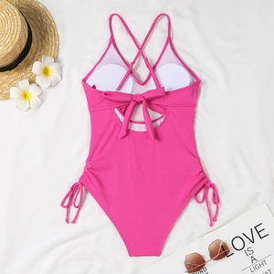 Detail of rose red one-piece swimsuit with ribbed texture and adjustable side drawstrings
