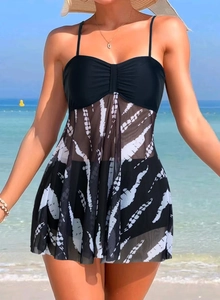 Detail of black bikini top with mesh skirt in black and white tie-dye on beach