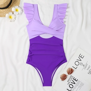 Detail of purple two-tone one-piece swimsuit with ruffle shoulders and cutout design