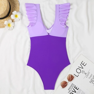 Flat lay of purple color-block one-piece swimsuit with ruffled straps and V-neckline
