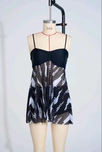 Detail view of black and white tie-dye mesh skirt tankini swimsuit on mannequin