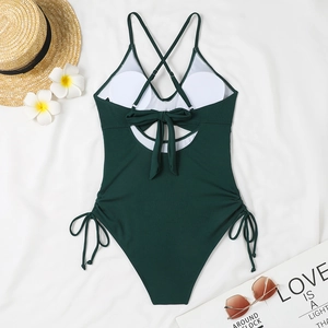 Detail of dark green ribbed one-piece swimsuit with lace-up back and side drawstrings