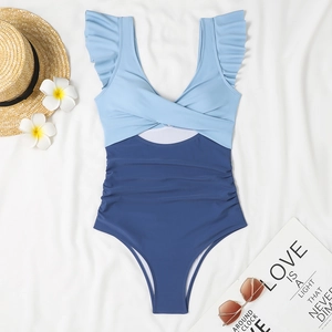 Flat lay detail of one-piece swimsuit featuring ruffled sleeves and waist cutout design