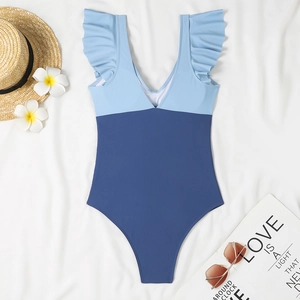Detailed view of one-piece V-neck swimsuit with blue color-blocking and ruffled shoulders