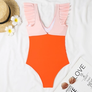 Detail of pink and orange one-piece swimsuit with ruffled sleeves and deep V-neck
