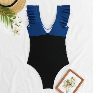 Detail of one-piece swimsuit with ruffled straps and contrast blue and black design