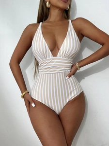 Detailed close-up of a striped V-neck one-piece swimsuit with vertical beige lines