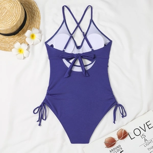 Flat lay of purple ribbed one-piece swimsuit with lace-up back and side drawstring details