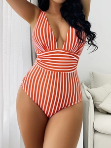 Detail of V-neck one-piece swimsuit featuring orange and white vertical stripes