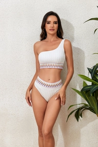 Close-up of white ribbed bikini featuring one-shoulder top and high-waisted zigzag trim