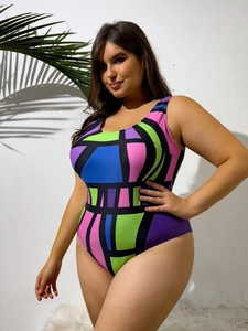 Detail of plus size one piece swimsuit with vibrant geometric color block patterns