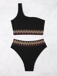 Detail of black one-shoulder bikini featuring colorful wavy zigzag embroidered edges