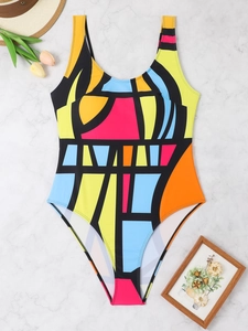 Flat lay of a plus size one-piece swimsuit with geometric abstract color block design