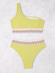 Detail of yellow high waisted bikini with colorful scalloped elastic trim and textured fabric