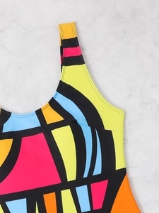 Detailed close-up of vibrant geometric color block swimsuit with durable double stitching