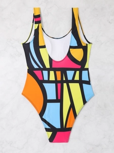 Detailed flat lay of a plus size one-piece swimsuit with vibrant geometric abstract patterns